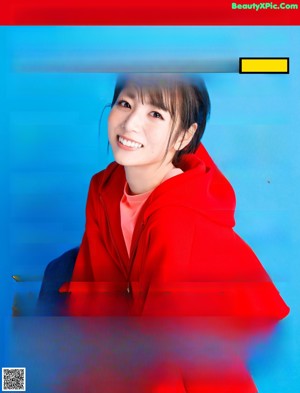 A poster for a Japanese movie with a woman in a red dress.