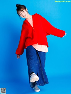 A woman in a red jacket posing for a picture.