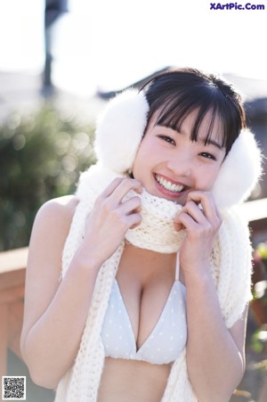 A woman in a purple bra and white gloves posing for a picture.