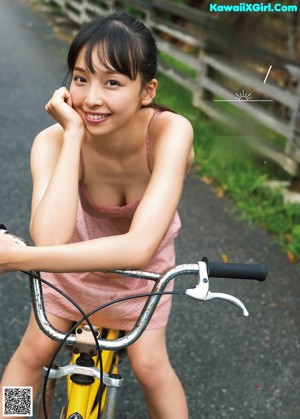 A woman in a red bikini posing for a picture.