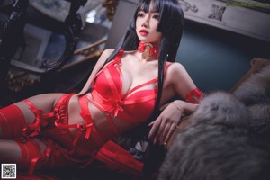 A woman in a red lingerie posing for a picture.