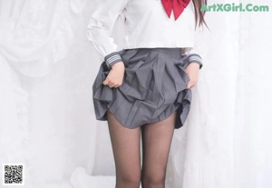 A woman in a black latex outfit posing for a picture.