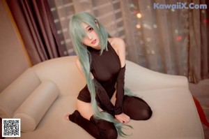 A woman sitting on a couch with her legs crossed.