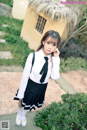 A young woman standing in front of a sliding door.