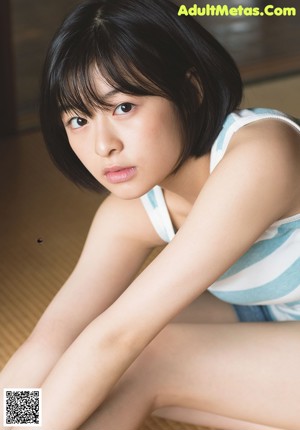 A woman in a sailor outfit is posing for a magazine cover.