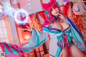 A woman in a kimono with pink hair and a cat ears.