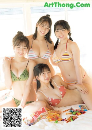 A group of young women laying on top of each other.