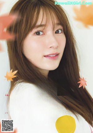 A woman with long brown hair is posing for a picture.